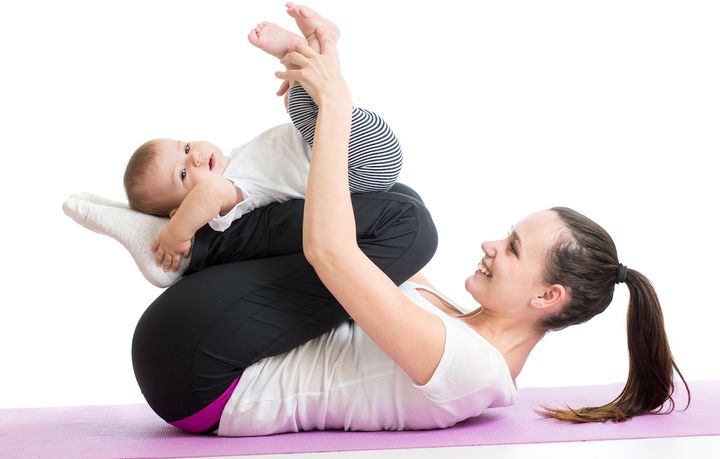 Mother Doing Yoga Exercise With Her Baby