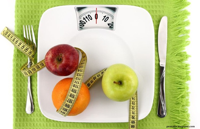 Fruits with measuring tape on a plate like weight scale